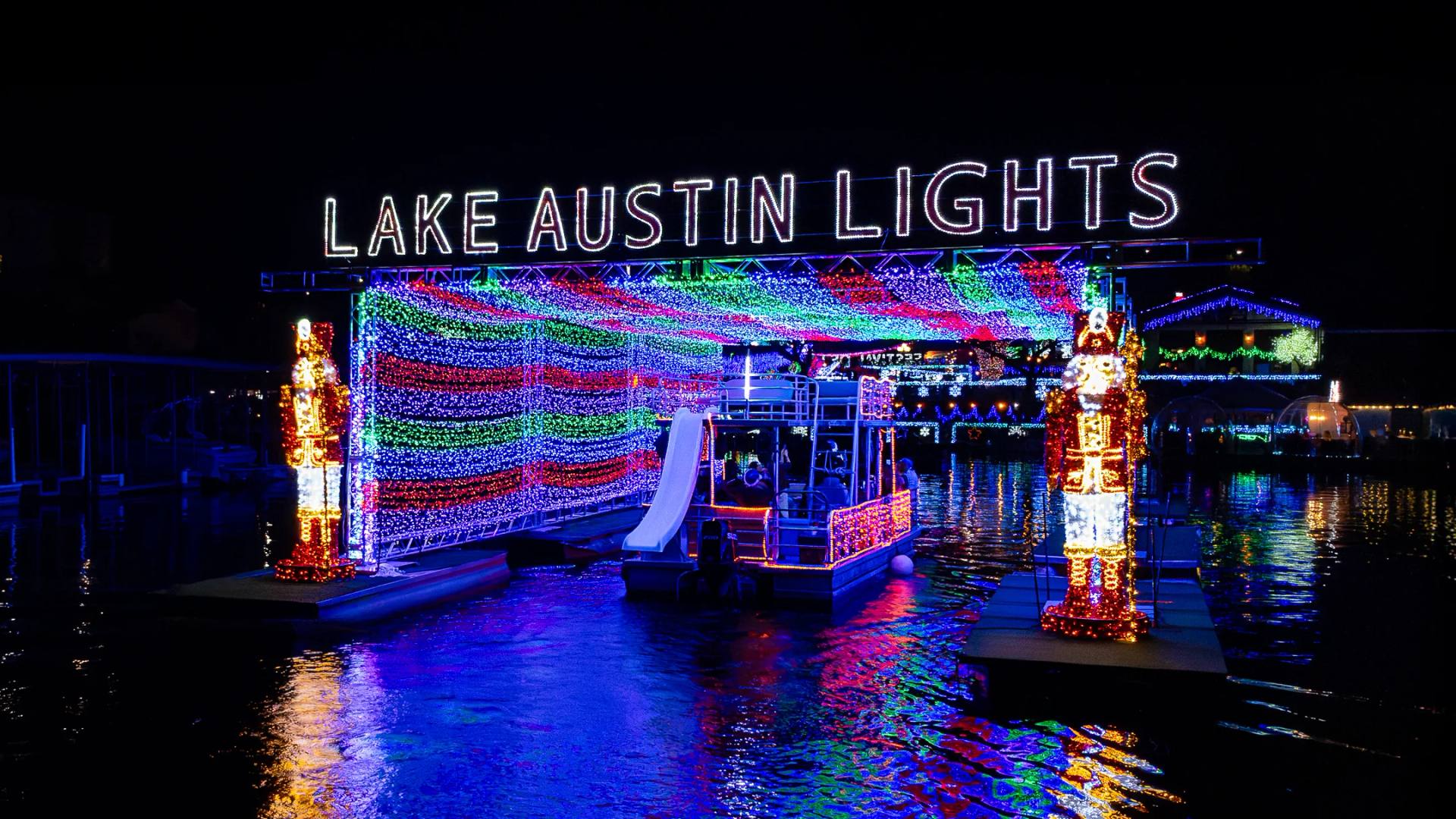 Lake Austin Lights — boats cruising through a floating tunnel of holiday lights